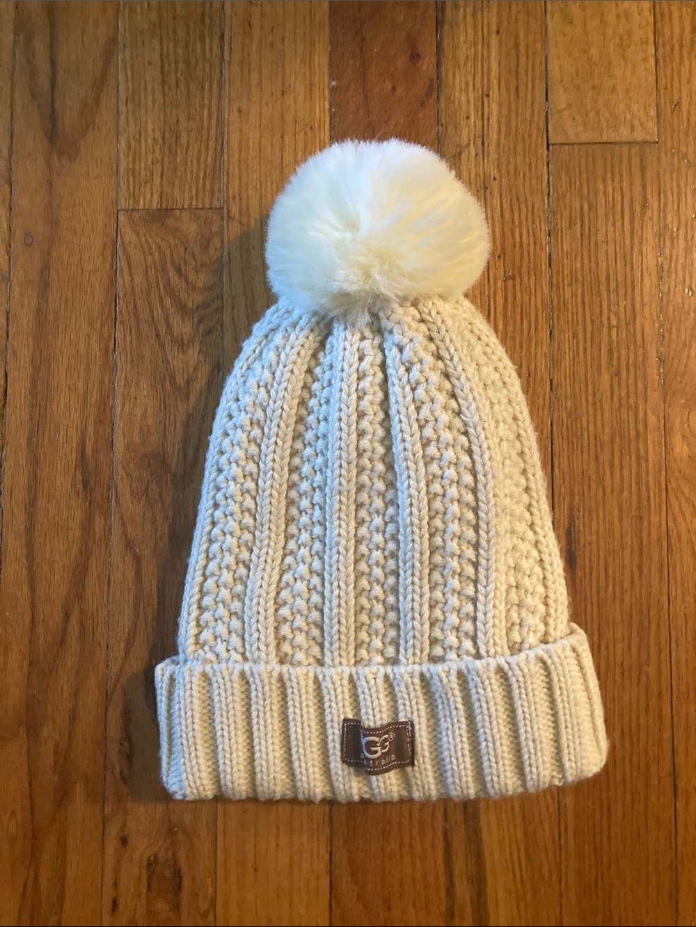 UGG Australia Ivory Knit Pom Beanie with brown fabric patch